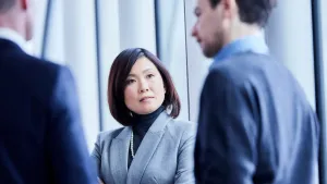 Three executives have a serious discussion about their marketing effort.